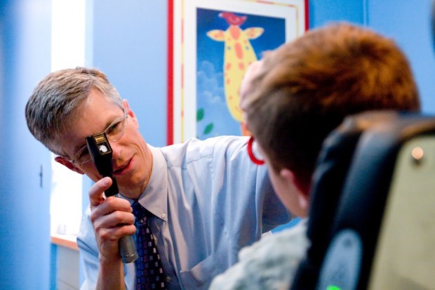 Dr. Stephen Christiansen examines a patient.